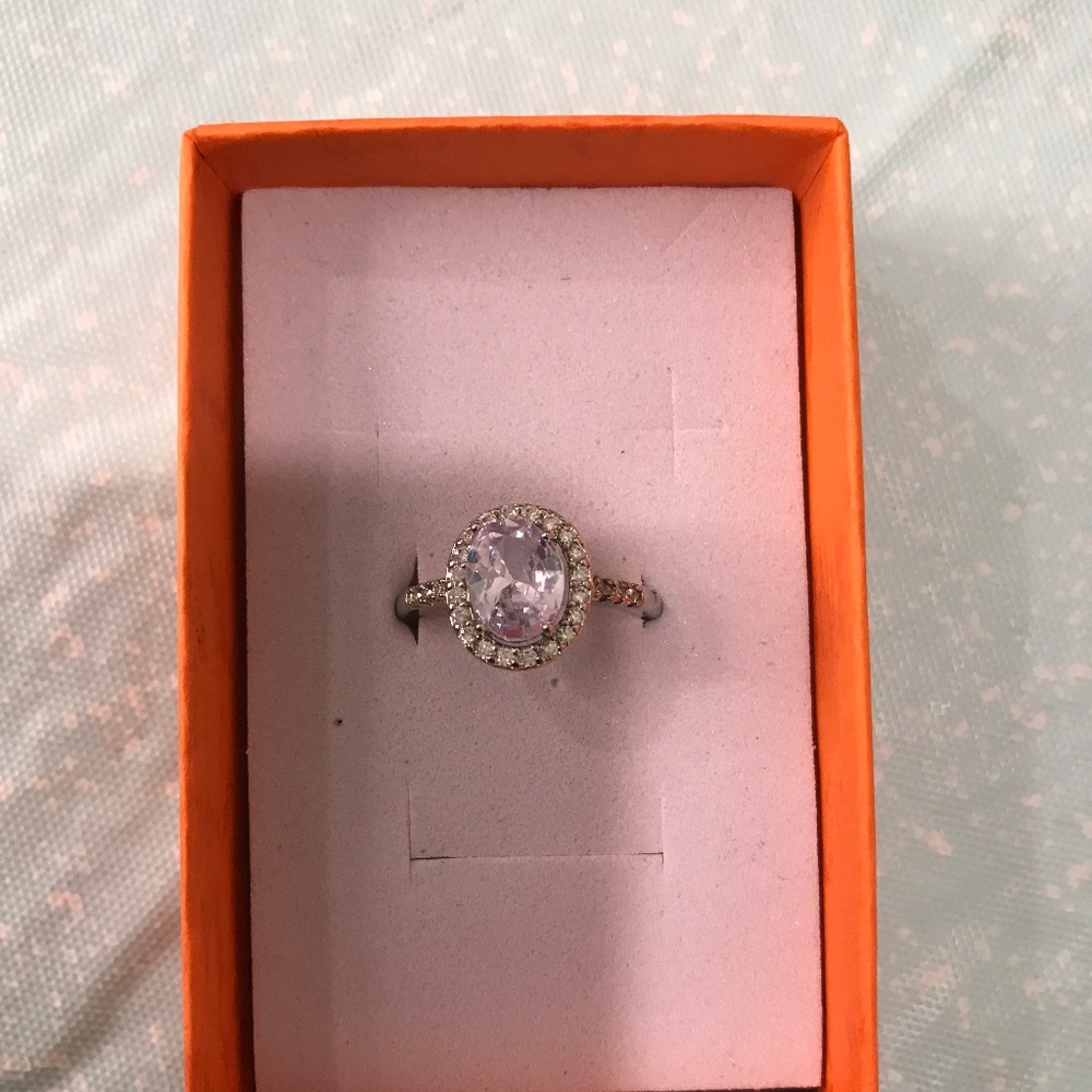Silver tone ring with oval stone and halo